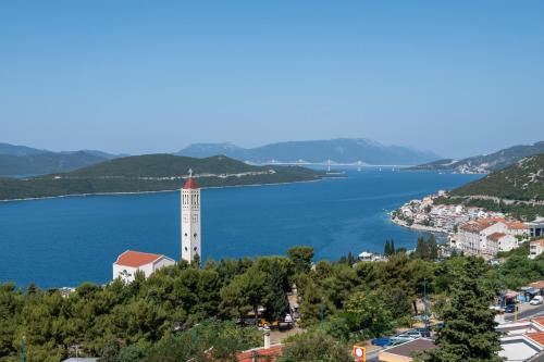 a view of a town with a clock tower and a body of water at Gabriel in Neum
