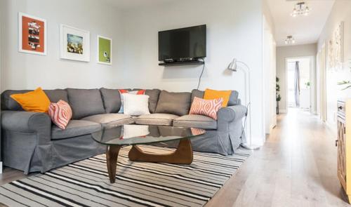 a living room with a couch and a table at Le Mont-Royal Lounge by HomeInMontreal in Montréal