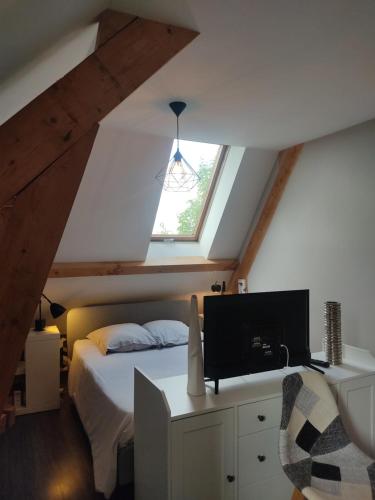 a bedroom with a bed and a window at Au P'tit Versailles in Châtillon-sur-Seine