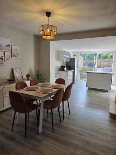a kitchen and dining room with a table and chairs at La Voie des Dunes in Bray-Dunes