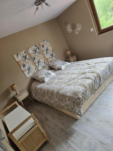 a bedroom with a bed and a chair and a window at La Voie des Dunes in Bray-Dunes