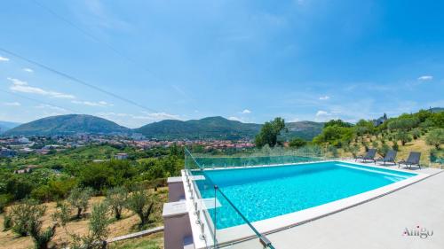 a pool in a villa with a view at Villa Panorama Olive Hill in Mostar