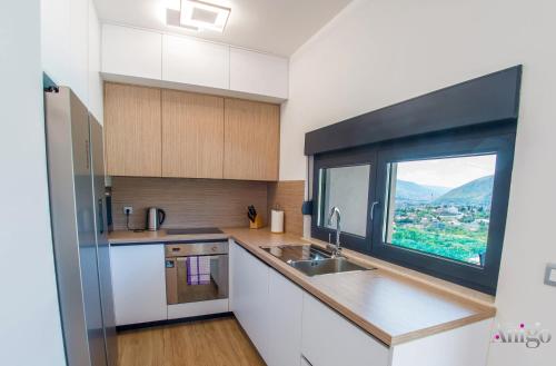 a kitchen with a sink and a window at Villa Panorama Olive Hill in Mostar