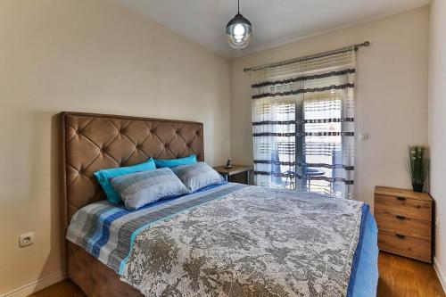 a bedroom with a large bed and a window at Apartment Alex in Bar