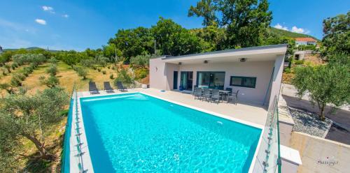 a villa with a swimming pool and a house at Villa Panorama Olive Hill in Mostar