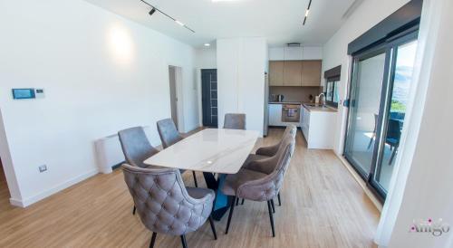 a kitchen and dining room with a table and chairs at Villa Panorama Olive Hill in Mostar