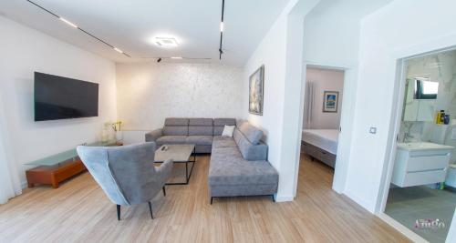 a living room with a couch and a table at Villa Panorama Olive Hill in Mostar