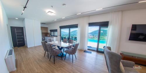 a kitchen and dining room with a table and chairs at Villa Panorama Olive Hill in Mostar