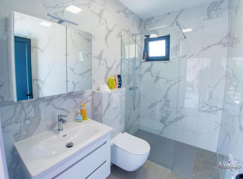 a bathroom with a sink and a shower and a toilet at Villa Panorama Olive Hill in Mostar