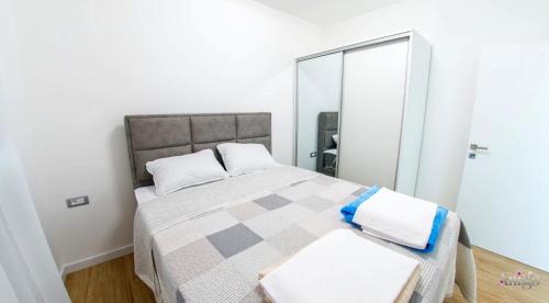 a bedroom with a large bed and a mirror at Villa Panorama Olive Hill in Mostar