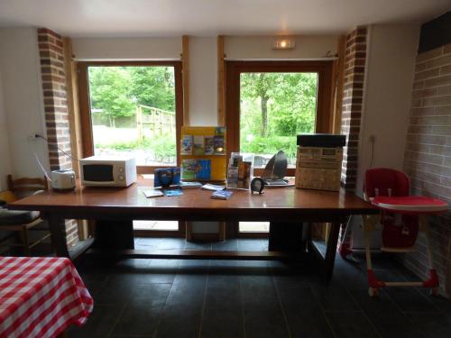 a large wooden table with boxes on top of it at La Ferme du Manoir Etretat in Bordeaux-Saint-Clair