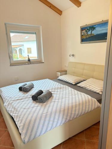 a bedroom with two beds with towels on them at Apartment Maja in Dobrinj