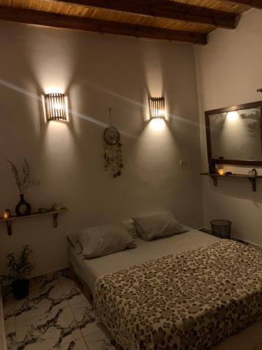 a bedroom with a bed and two lights on the wall at Rayan stay 1 in Dahab