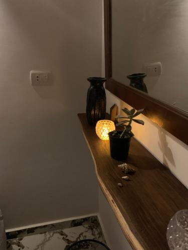 a counter with two vases and a plant on it at Rayan stay 1 in Dahab