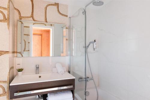 a bathroom with a sink and a mirror at Best Western Ronceray Opéra in Paris