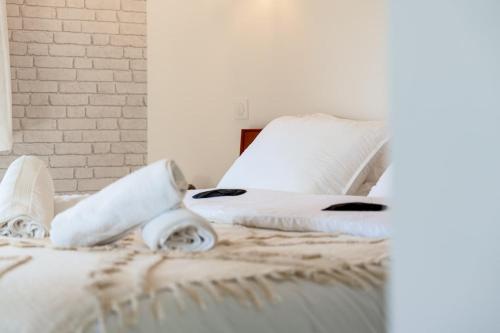 a bed with white sheets and pillows on it at Duplex unique à Duppigheim 20 min de Strasbourg in Duppigheim
