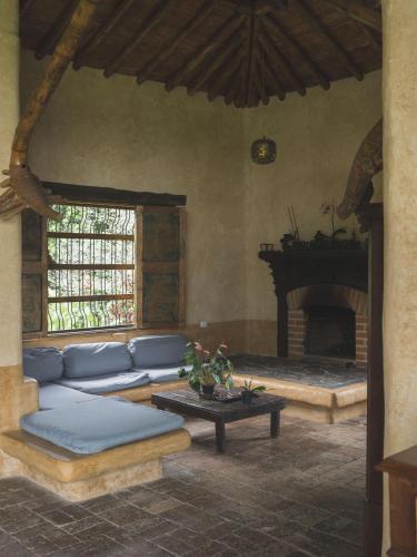 a living room with a couch and a fireplace at Cabañas en la montaña Viga Vieja in San Peregrino