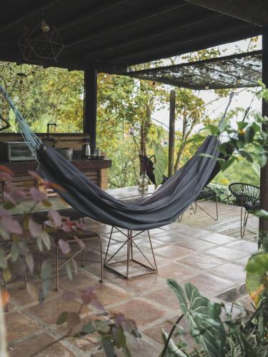 a hammock in a screened in porch at Cabañas en la montaña Viga Vieja in San Peregrino