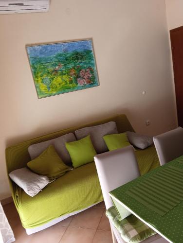 a couch in a living room with a painting on the wall at Apartman Jadranka in Zaboric