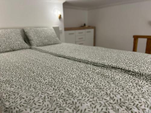 a bedroom with a bed with a white comforter at Museum Apartment by City Park Budapest in Budapest