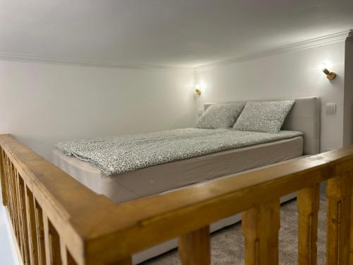 a bed sitting on a wooden platform in a bedroom at Museum Apartment by City Park Budapest in Budapest
