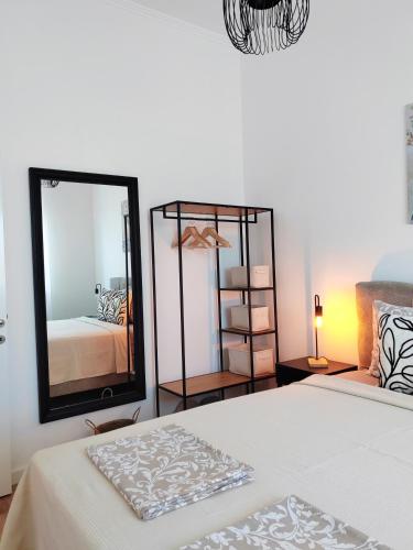 a bedroom with a bed and a large mirror at Apartman Lola Palić I in Palić