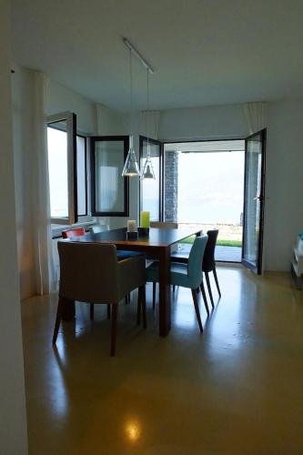 a dining room table and chairs in a room at Casa Panorama in Brissago