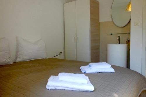 due asciugamani appoggiati sopra un letto di Casa Panorama a Brissago