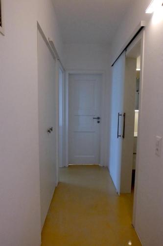an empty hallway with a white door in a room at Casa Panorama in Brissago