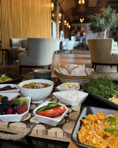 a table topped with bowls and plates of food at إيلاف الدمام للوحدات السكنية المخدومة in Dammam