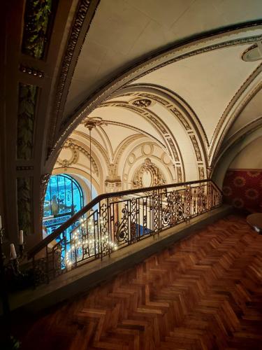 a hallway with a staircase in a building at Nostalgia Old City Bucharest in Bucharest