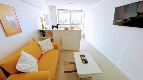 a living room with a couch and a table at 3375 Home - A pasos de Montevideo Shopping, la playa y WTC in Montevideo