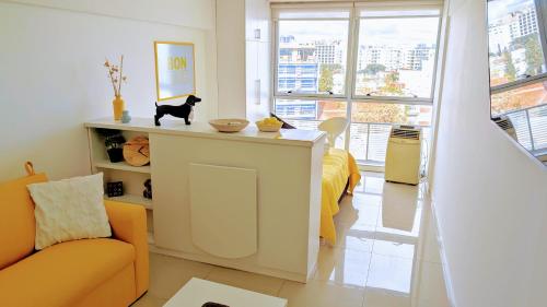 a living room with a cat sitting on a counter at 3375 Home - A pasos de Montevideo Shopping, la playa y WTC in Montevideo
