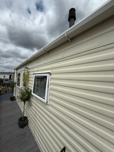 a building with a window on the side of it at Andreas Fir Trees Retreat at 7 Lakes Country Park in Crowle