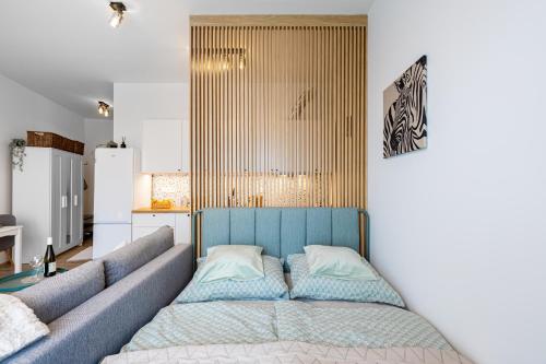 a living room with a couch and a kitchen at Terrace&RelaxStudio free parking in Bratislava