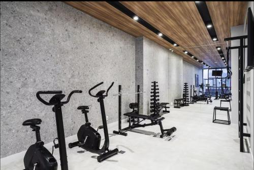 a gym with a row of exercise bikes and treadmills at Trink Home in Sao Paulo