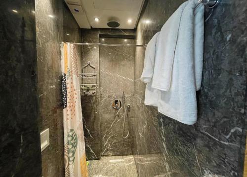 a bathroom with a shower with a glass door at Luxury Modern Studio with Netflix, Kitchen and Free Parking Elite Garden, Marrakesh in Aït Saïd