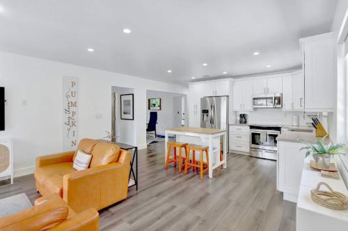 a kitchen and living room with a couch and a table at Orange Dream in the Sky in Fort Lauderdale