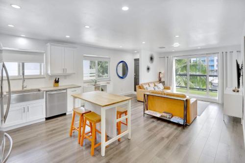 a kitchen and living room with a table and a couch at Orange Dream in the Sky in Fort Lauderdale