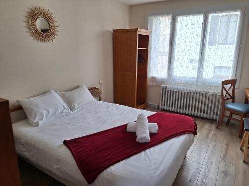 a bedroom with a bed with a towel on it at La cocotte in Soullans