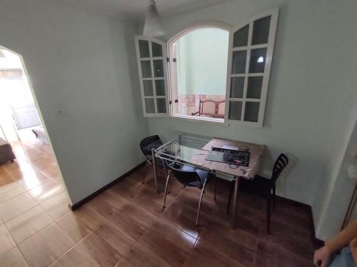 a dining room with a glass table and chairs at República Minas Novas in Ouro Preto