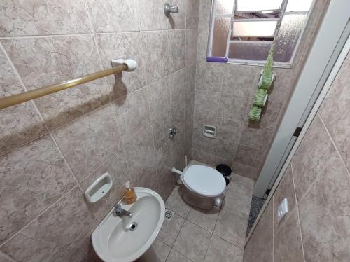 a bathroom with a toilet and a sink at República Minas Novas in Ouro Preto