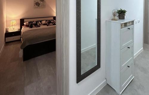 a bedroom with a bed and a mirror on the wall at Gorgeous Apartment In Kastel Stari in Kastel Stari