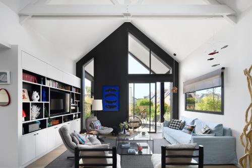 a living room with white walls and a large window at Les Villas Majolie - Villa 13 Océan - 5 étoiles in Combrit