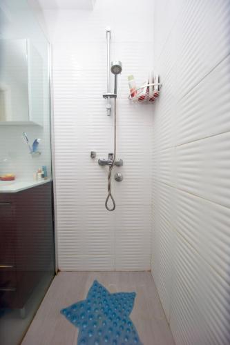 a bathroom with a shower with a blue star on the floor at Casa Mimosa Bright and Soulful in Budva