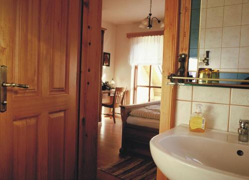 a bathroom with a sink and a room with a bed at Turisticna Kmetija Pudvoi in Bizeljsko