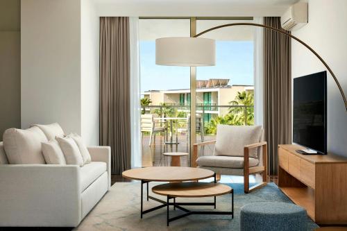 a living room with a couch and a table at Marriott Residences Salgados Resort, Algarve in Albufeira