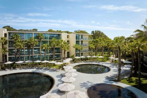 an image of a resort with two pools and umbrellas at Marriott Residences Salgados Resort, Algarve in Albufeira