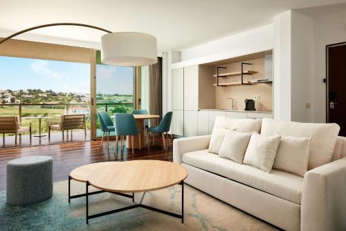 a living room with a couch and a table at Marriott Residences Salgados Resort, Algarve in Albufeira