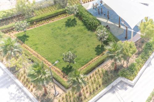 an overhead view of a park with palm trees at Damac Hills cozy studio for 2 people in Dubai Marina
